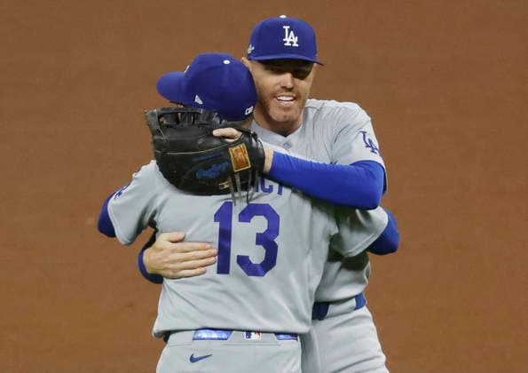 Los Angeles Dodgers first baseman Freddie Freeman (5) celebrates with third baseman Max Muncy (13) after the Dodgers defeated the Atlanta Braves 4-1 in an MLB, Baseball Herren, USA National League Division Series playoff game at Truist Park in Atlanta, Georgia, on Wednesday, October 7, 2026. The Dodgers win the series 3 games to 1 and advance to the Championship round.  ATL20261007722 MIKExZARRILLI