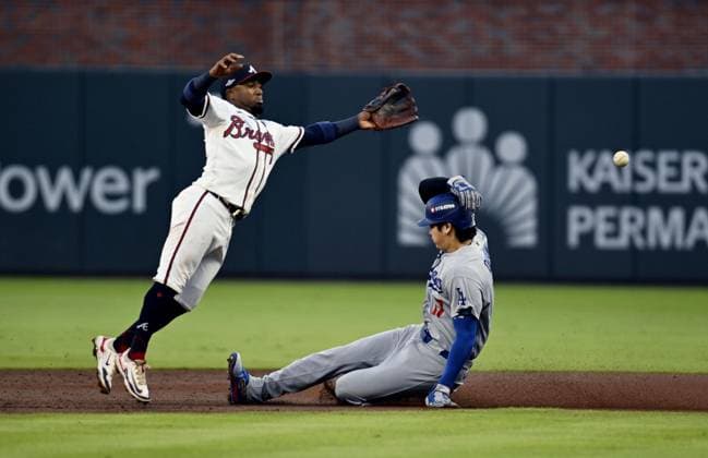 Baseball: Division Series between Dodgers and Braves Los Angeles Dodgers designated hitter Shohei Ohtani (R) steals second base as Atlanta Braves second baseman Ozzie Albies fails to gather the ball during the second inning of Game 4 of the National League Division Series at Truist Park in Atlanta on Oct. 7, 2026.  A14AA0005630402P