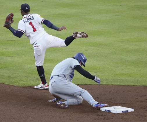 Baseball: Division Series between Dodgers and Braves Los Angeles Dodgers designated hitter Shohei Ohtani steals second base as Atlanta Braves second baseman Ozzie Albies (1) fails to gather the ball during the second inning of Game 4 of the National League Division Series at Truist Park in Atlanta on Oct. 7, 2026.  A14AA0005630403P