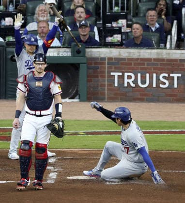 Baseball: Division Series between Dodgers and Braves Los Angeles Dodgers designated hitter Shohei Ohtani (R) slides home safely after a fielding error by Atlanta Braves shortstop Mauricio Dubon as Braves catcher Sean Murphy (L) looks on during the second inning of Game 4 of the National League Division Series at Truist Park in Atlanta on Oct. 7, 2026.  A14AA0005630407P