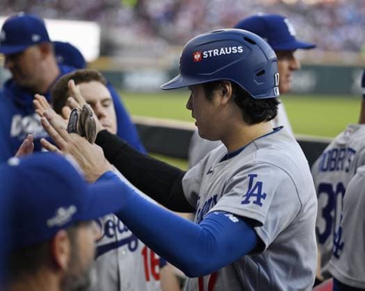 Baseball: Division Series between Dodgers and Braves Los Angeles Dodgers designated hitter Shohei Ohtani celebrates with teammates after scoring on a fielding error by the Atlanta Braves during the second inning of Game 4 of the National League Division Series at Truist Park in Atlanta on Oct. 7, 2026.  A14AA0005630411P