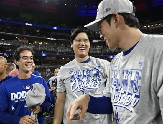 Baseball: Division Series between Dodgers and Braves Los Angeles Dodgers designated hitter Shohei Ohtani (C), pitcher Roki Sasaki (R) and interpreter Will Ireton celebrate after winning Game 4 of the National League Division Series against the Atlanta Braves at Truist Park in Atlanta on Oct. 7, 2026, and advancing to the National League Championship Series.  A14AA0005630422P