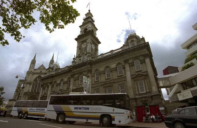 Parkende Reisebusse vor dem Rathaus von Dunedin in Neuseeland