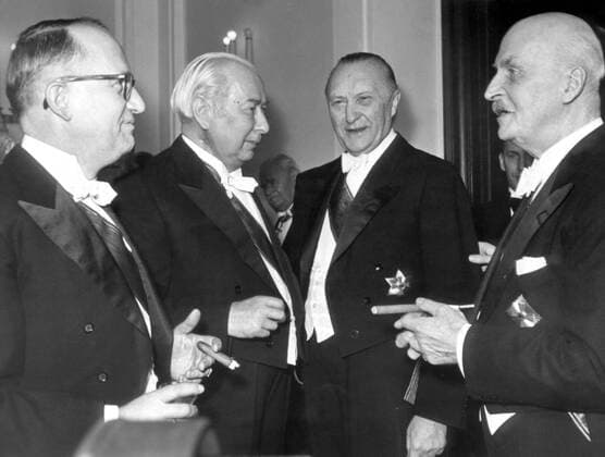 Jan 31, 1954 - Bonn, Germany - West Germany s first chancellor KONRAD ADENAUER began his career in politics as a member of the Cologne City Council, becoming lord mayor of the city. After the Nazis came to power in 1933, Adenauer, who had not hidden distaste for them, lost his positions, was forced to go into exile for a year in an abbey and was later interned in a prison camp. Adenauer was elected Chancellor of the Federal Republic of Germany on 15 September 1949. His main aim was to ensure West Germany s transition to a sovereign, democratic state. He held power for the next fourteen years and during that time played an important role in restoring good relations with France and the United States. PICTURED: Prof. Dr. WALTER HALLSTEIN, Prof. Dr. THEODOR HEUSS, KONRAD ADENAUER and ERNST MECKLENBURG during a reception in Villa Hammerschmidt. Bonn Germany  - ZUMAk09