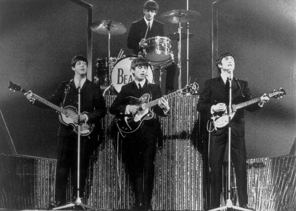 London, England, UK - THE BEATLES members PAUL MCCARTNEY, GEORGE HARRISON, RINGO STARR and JOHN LENNON pictured during a concert. One of the most commercially successful and critically acclaimed bands in the history of popular music, the Beatles led the mid-1960s musical British Invasion into the United States. Landing on these shores on February 7, 1964, they literally stood the world of pop culture on its head, setting the musical agenda for the remainder of the decade. London UK  - ZUMAk09