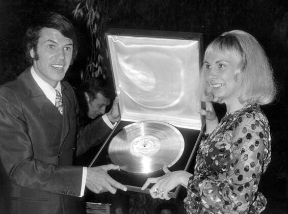 Oct 07, 1969; Paris, France; The famous Italian Belgian singer, SALATORE ADAMO, who is now celebrating his 30 millionth disc was awarded a gold record by Pathe Marcani. In the picture is Salvatore Adamo and his wife NICOLE ADAMO pictured with the gold record. Paris France  - ZUMAk09