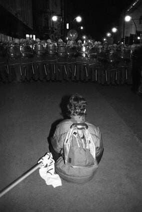 Velvet Revolution. Demonstrator sits on the ground in front of a police cordon at Narodni trida in Prague with his banner rolled up, Czechoslovakia on November 17, 1989. The events of November 1989 started by brutally supressed student demonstration led to government fall and the end of Communist regime in Czechoslovakia. (CTKxPhoto PavelxHroch) 
