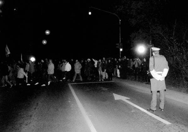 Czechoslovakia, Velvet Revolution, November 1989, demonstrators peacefuly pass a police officer. 