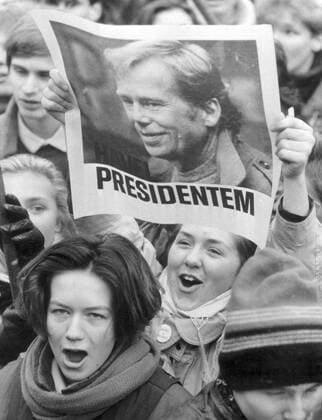Velvet Revolution, Prague November 17, 1989. At the 50th anniversary of closing of universities by German occupational forces and subsequent death of Jan Opletal, about 15 000 students commemorate this event. Soon after the demonstrating students were met by herds of police officers who brutally beat many of them. This chain of events contributed to the defeat of the Czechoslovak Communist Party and led to Vaclav Havel´s innaguration. Havel was the first democratic president elected since the 1948 Communist takeover. Photo shows supporters of Vaclav Havel to be the next president. Woman lifts poster with his image. 