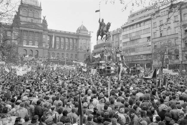 Prague, Velvet Revolution, November 27 1989, hundreds of thousands of demonstrators stage their support to striking students during a two hour general strike that took place on the rest of the republic. Students, together with mothers with children, nurses and doctors, actors and writers protest at Old Town Square. The Communist regime is just about to crumble down. Protestors with Czech flags and banners at Wenceslas Square. Protestors are seen near the statue of St. Wenceslas. 