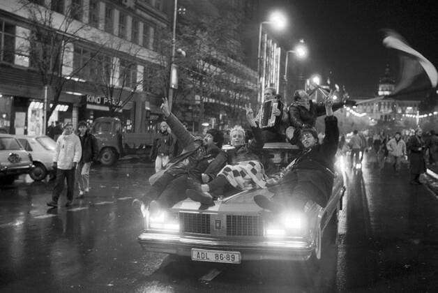 Czechoslovakia, November 24th 1989, Velvet Revolution, euphoric Prague citizens laying on an imported American car happily celebrate the announcement that Communist government including the high ranking officials at the Communist Party of Czechoslovakia resigned their posts. 