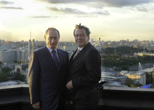 President of Russia Vladimir Putin (L) and German Chancellor Gerhard SchrÃ¶der (R) on the balcony of President-Hotel .  TASS_124402