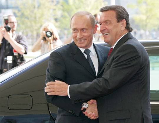 ITAR-TASS 48: BERLIN, GERMANY. SEPTEMBER 8. Russian President Vladimir Putin (L) and German Chancellor Gerhard SchrÃ¶der smile for the press outside the Chancellor s department.  TASS_177621