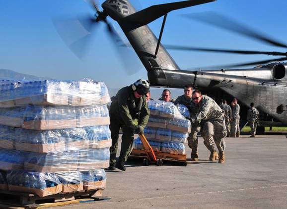 U.S. Army soldiers unload food and supplies on January 15, 2010 from a U.S. Navy MH-53E Sea Dragon helicopter from the aircraft carrier USS Carl Vinson (CVN 70) at the airport in Port-au-Prince, Haiti. The U.S. military is conducting humanitarian and disaster relief operations after a 7.0 magnitude earthquake caused severe damage near Port-au-Prince on January 12.  WAX20100115722