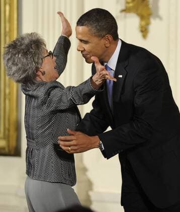 U.S. President Barack Obama hugs Rita Moreno before he awards her the 2009 National Arts Medal during a ceremony in the East Room of the White House in Washington on February 25, 2010. Moreno, a Puerto Rican singer, dancer and actress, is the first and only Hispanic and one of ten performers who have won an Emmy, a Grammy, an Oscar, and a Tony.  WAP20100225522