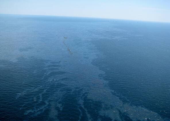 Debris and oil from the Deepwater Horizon drilling platform float in the Gulf of Mexico after the rig sank on April 22, 2010. The mobile offshore drilling platform was engulfed in flames after an explosion April 20, and sank two days later. Eleven missing workers are feared dead. The Coast Guard said on April 23, 2010 that no oil appeared to be leaking from the well head on the ocean floor, some 5000 feet below.  WAX20100423103