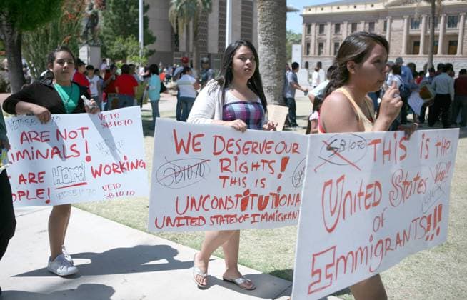 Demonstrators march in front of the Arizona Capital Building to voice their opposition to the passing and subsequent signing by Governor Brewer of the Arizona Senate Bill 1070 which will effect immigrants in Arizona, in Phoenix, AZ, April 25,2010.  PXP2010042509