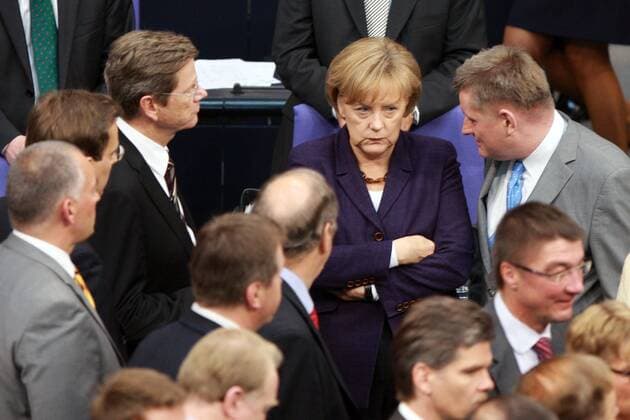 (100507) -- BERLIN, May 7, 2010 (Xinhua) -- German Chancellor Angela Merkel (C, back row) listens at the lower chamber of parliament after voting for the Greece rescue package in Berlin May 7, 2010. Germany s lower chamber of parliament on Friday approved its share in a multi-billion-euro rescue package for debt-laden Greece. (Xinhua Luo Huanhuan)(dyw) GERMANY-BERLIN-GREECE RESCUE PACKAGE 