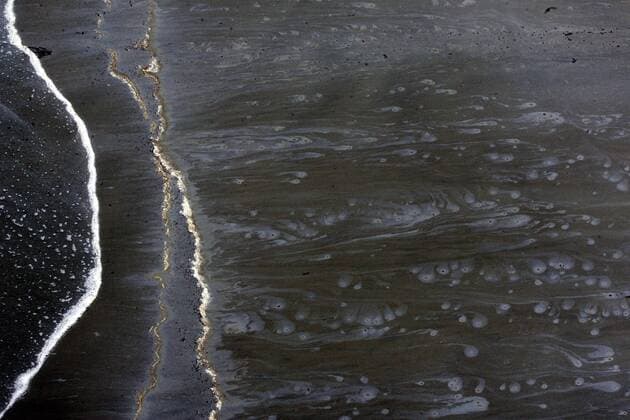 Oily tar balls that have washed up from high seas associated with Hurricane Alex leave patterns on the beach at Grand Isle, Louisiana June 30, 2010. Oil has been leaking into the Gulf of Mexico since April when a massive explosion on the BP oil rig Deepwater Horizon, creating the worse spill in U.S. history.  NOP2010063004