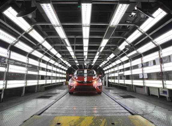 Chinese workers assemble Ford and Volvo cars at a Chang an Ford automobile assembly factory in Chongqing August 25, 2010. Chang an Ford is Ford Motor Company s China car-making joint venture. China is the hottest auto market by number of vehicles sold, and automakers are looking to the country to drive revenues amid weak global demand.  CKG2010082528