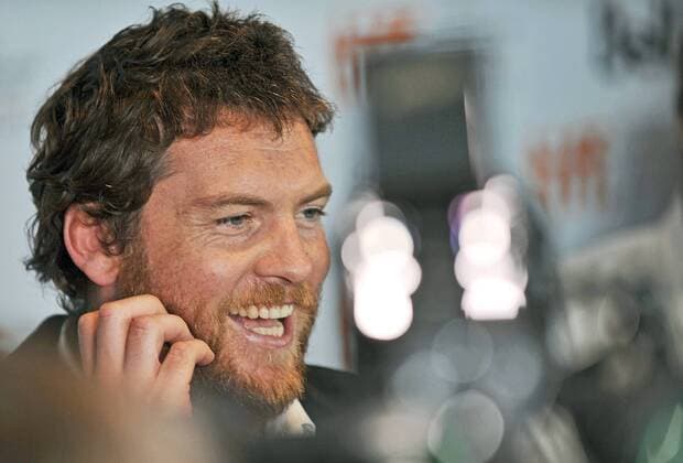 Actor Sam Worthington is surrounded by TV lights as he speaks to reporters on the red carpet at the world premiere of Last Night at Roy Thomson Hall on closing night of the Toronto International Film Festival in Toronto, Canada on September 18, 2010.  TOR2010091834