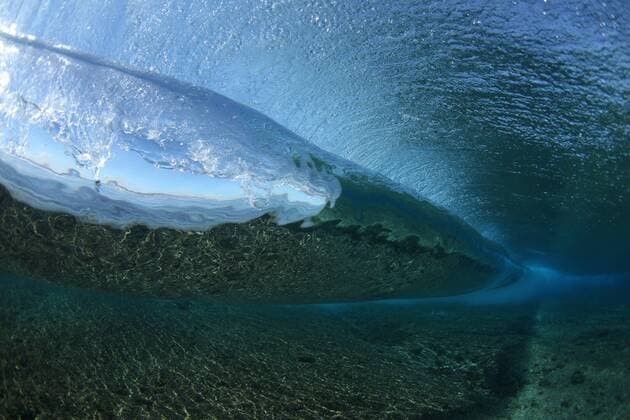 A view from underwater of a perfect wave breaking off of TavaruaI Island, on the south west side of the Fijian Mamanucas Island Chain - JuergenxTap