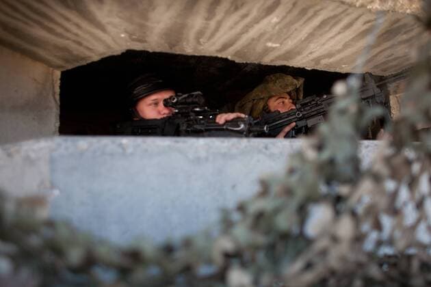 (101110) -- GHAJAR (ISRAEL), Nov. 10, 2010 (Xinhua) -- Israeli soldiers are seen in an army outpost in the village of Ghajar, located on the Israel-Lebanon border, on Nov.10, 2010. The possibility that Israel will implement the withdrawal from the northern part of the village of Ghajar is higher than ever due to the high interest of Prime Minister Binyamin Netanyahu and Foreign Minister Avigdor Lieberman, local media reported. Following the 2006 war between Israel and Hezbollah, Israel promised to leave the northern part of Ghajar in accordance with UN Security Council resolution 1701. The division of the village has often been used by Hezbollah as a reason for continued hostility towards Israel. (Xinhua JINI) MIDEAST-ISRAEL-SYRIA-GHAJAR-WITHDRAWAL 