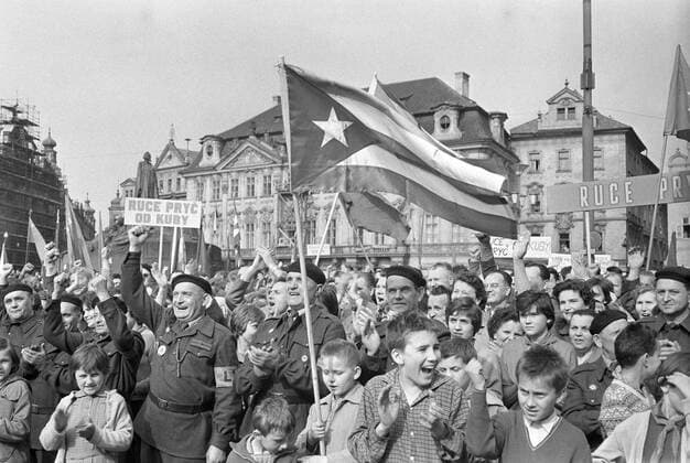School children and members of workers paramilitary People s Militia wave Cuban flags and shout slogans as they condemn the US-led invasion of Cuba during a state-organised protest rally at the Old Town Square in Prague, April 19, 1961. CTK Photo Jan Tachezy  CTKPhoto03008543