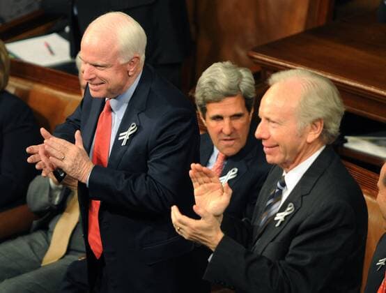 U.S. President Barack Obama State of the Union address is applauded by Republican Senator John McCain (L), Democrat Senator John Kerry (C) and Independent Senator Joe Lieberman (R) during a Joint Session of Congress in the House Chamber of the U.S. Capitol in Washington on January 25, 2011. Some Republicans and Democrats crossed the aisle to show signs of unity in the government. Obama focused on the economy and especially job creation.  WAP20110125107