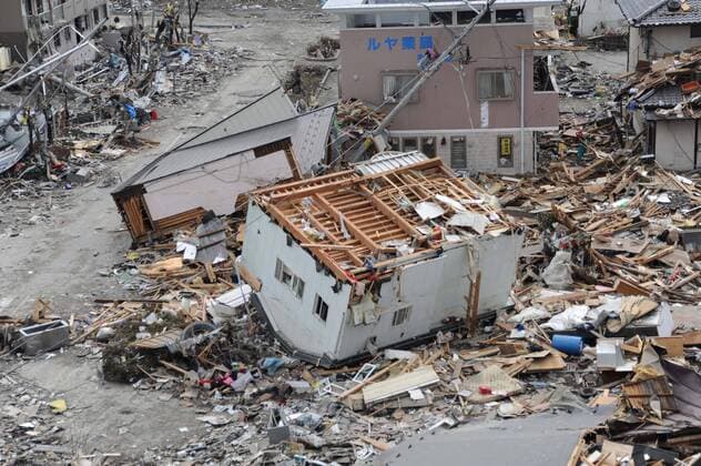 OFUNATO, Japan (March 15, 2011) An upended house is among debris in Ofunato, Japan, following a 9.0 magnitude earthquake and subsequent tsunami.  ( 20114191)