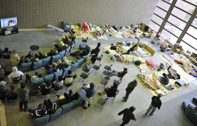(110320) -- FUKUSHIMA, March 20, 2011 (Xinhua) -- Japanese watch news on TV inside a sports park used as a makeshift shelter in Fukushima, Japan, March 19, 2011. Residents around the Fukushima No. 1 nuclear power plant were evacuated to shelters to avoid radioactive hurt after nuclear leakage. Evacuees here were waiting in calm and orderliness for going back home. (Xinhua Huang Xiaoyong) (ybg) JAPAN-FUKUSHIMA-SHELTER-LIFE 
