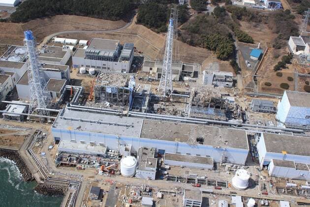 In this March 20, 2011 aerial photo taken by small unmanned drone and released by AIR PHOTO SERVICE, the crippled Fukushima Dai-ichi nuclear power plant is seen in Okumamachi, Fukushima prefecture, northern Japan. From right to left, Unit 1 through Unit 4.  (pvaa012478)