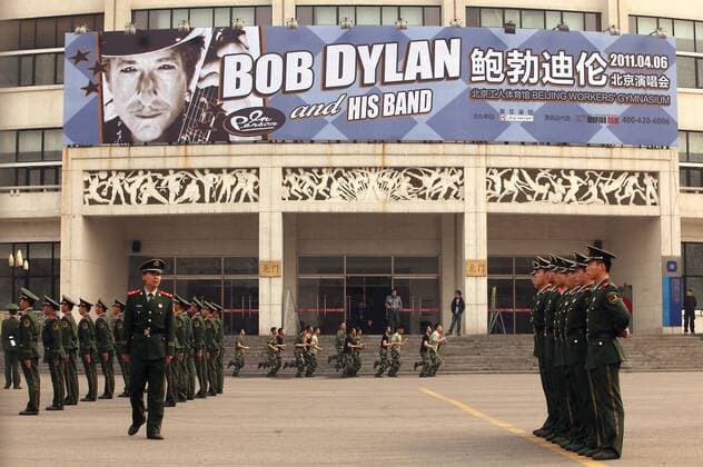 Chinese soldiers take their positions in front of Beijing s iconic Worker s Gymnasium, which will host Bob Dylan s first-ever concert in China, on April 6, 2011. Last year Chinese authorities refused to allow the legendary protest singer Bob Dylan to play concerts inside China. Chinese censors were wary of his politically charged lyrics, which inspired a generation of Americans in the 1960s and 70s to question authority in a way that is forbidden in China. Officials said the singer would have to strictly abide by an agreed playlist.  PEK2011040601