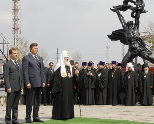 CHERNOBYL, UKRAINE. APRIL 26. 2011. President of Russia Dmitry Medvedev, Ukrainian President Viktor Yanukovich (Victor Yanukovych), and Patriarch Kirill of Moscow and All Russia (L-R) visit the memorial to honour participants in the clean-up after the Chernobyl nuclear disaster, known as liquidators, during the events marking the 25th anniversary of the tragedy.  RE0E5B63