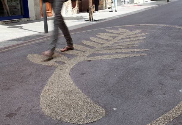 A woman walks over a Palm d Or , the symbol of the Cannes Film Festival, the day before the 64th annual Cannes International Film Festival opens in Cannes, France on May 10, 2011.  CAN20110510705
