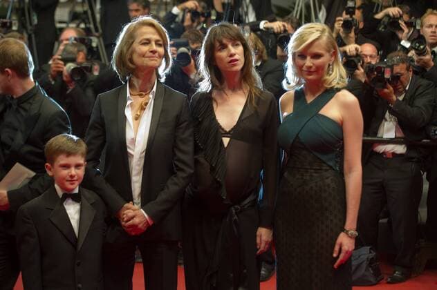 FRANCE, Cannes : Charlotte Rampling Charlotte Gainsbourg US actress Kirsten Dunst pose on the red carpet before the screening of Melancholia presented in competition at the 64th Cannes Film Festival on May 18, 2011 in Cannes. 