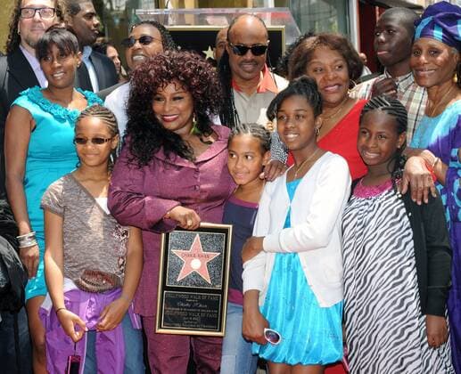 Singer Chaka Khan (C) holding a replica plaque, is surrounded by friends and family members, including musician Stevie Wonder, center, rear, during an unveiling ceremony as she receives the 2,440th star on the Hollywood Walk of Fame in Los Angeles on May 19, 2011.  LAP2011051911