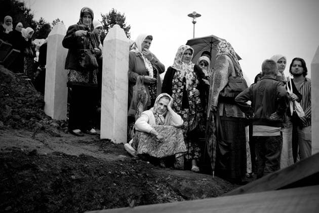 BOSNIA AND HERCEGOVINA , POTOCARI 11 07 2009 From 11th July 1995 in Srebrenica, the safe zone protected by UN forces Serbs killed in ethnic cleansing more than 8000 Bosniak man. Dozen years after the largest genocide in Europe since World War II mass graves are still being found and exhumed, in the mortuaries thousands of bodies await for identification, funerals take place, families of the victims wish to bury and mourn their relatives. HERE Once a year, on the anniversary of the Serb attack on Srebrenica, the funeral of all the victims identified over the whole previous year takes place. During the 14th anniversary 534 including 1 woman were buried. In the funeral took part approximately 20.000 people. EN_00922060_0005 