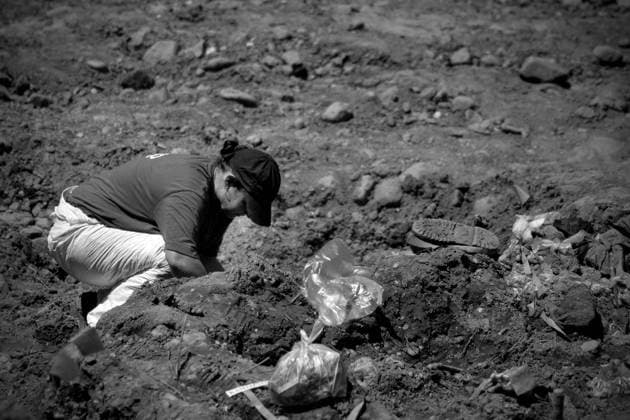 BOSNIA AND HERCEGOVINA , KAMENICA 14 07 2009 From 11th July 1995 in Srebrenica, the safe zone protected by UN forces Serbs killed in ethnic cleansing more than 8000 Bosniak man. Dozen years after the largest genocide in Europe since World War II mass graves are still being found and exhumed, in the mortuaries thousands of bodies await for identification, funerals take place, families of the victims wish to bury and mourn their relatives. HERE Exhumation of a mass grave - it is a so called secondary grave (primary grave in which the victims were burried was dug out in order to coneal the crime and the bodies were transferred into various better disguised different places). EN_00922060_0044 