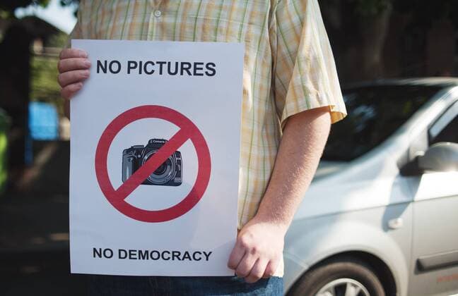 ITAR-TASS: TBILISI, GEORGIA. JULY 14, 2011. Demonstrator holds a sign reading No Pictures. No Democracy during a protest outside the residence of president Saakashvili, in support of photo journalists arrested on charges of spying for Russia. The protest was organized by journalists representing a number of Georgian media organisations.  RE0EAA06