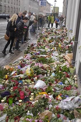 DENMARK COPENHAGEN Norwegian flag half mast at embassy and People laying flowers at doorr step Norwegian Embassy in Copenhagen Amaliegade 39 in sorrow of tragedy of 91 people been killed by gund mand bomb blast on July 22, 2011 in Norwegian captila Oslo, here in Copenhagen children,family,women and men laying flowers at door step of Norwegain Embassy today saturday 24 July 2011 