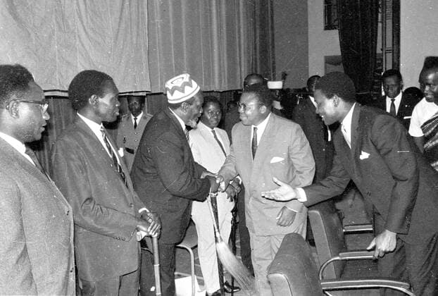 Leopoldville , Congo : Congo President Joseph Kasavubu ( wearing glass ) greets Kenya Leader Jomo Kenyatta at the opening session of the Pan African Freedom Movement for Eastern , Central and Southern Africa Conference in Leopoldville . On left is Uganda Premier Milton Obote and right Congo Foreign Minister Justin Bomboko . 1 January 1962 Mono Negative !AUFNAHMEDATUM GESCHÄTZT! UnitedArchives1168115
