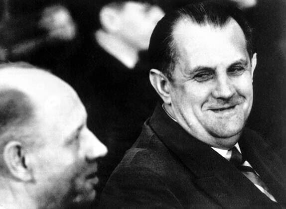 During the first session of the Auschwitz trial in the new courtroom at a Frankfurt Civic Theatre , defendant Oswald Kaduk (right) , former Gestapo guard accused of breaking inmates necks with a favourite pick , turns to smile at his neighbour , Emil Hantl , Frankfurt , Germany . The trial , in which 22 persons are accused of killing millions at the notorious Auschwitz concentration camp . 3 April 1963 Mono Negative !AUFNAHMEDATUM GESCHÄTZT! UnitedArchives1273001