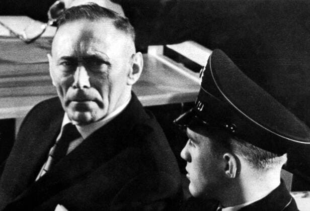 Wilhelm Boger , 56 (left) , once a sergeant in the Auschwitz concentration camp Gestapo staff , is pictured when he and 21 other guards and officials went on trial charged with the responsibility for the extermination of more than 2 1 2 million people at the camp , Frankfurt , Germany . Boger is charged with such crimes as the single handed shooting of 100 Red Army officers , drowning a priest by holding his head in a bucket of water and kicking a Polish General to death . Several torture devices used at the camp were said to have been invented by Boger . 20 December 1963 Mono Negative !AUFNAHMEDATUM GESCHÄTZT! UnitedArchives1273002