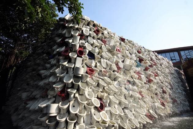 FOSHAN, CHINA - NOVEMBER 13: (CHINA OUT) A view of an art wall made of thousands of closestools is seen at Shiwan Park on November 13, 2011 in Foshan, Guangdong Province of China. 10 thousand waste toilets and washbowls were built into 100 meters in length, 5 meters height art landscape wall. Some of them were the waste of factories, while others were the donations of domestic and foreign enthusiasts. After the two months collection process, those were installed by certain angles. The toilet waterfall implicates creativity may change life and ideas. It spreads the concept of regional culture and industrial development and the scene of flowing water letting people can t help producing a pleasant sensation in Physiology or psychology-side.  CFP423036732