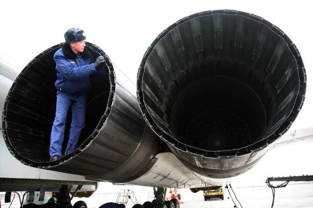 ITAR-TASS: SARATOV REGION, RUSSIA. DECEMBER 5, 2011. A serviceman checking engines of the Tupolev Tu-160 (NATO reporting name: Blackjack) supersonic bomber, at the Engels Air Force Base (aka Engels-2, Engel s, or Zngyelse).  RE0F3396