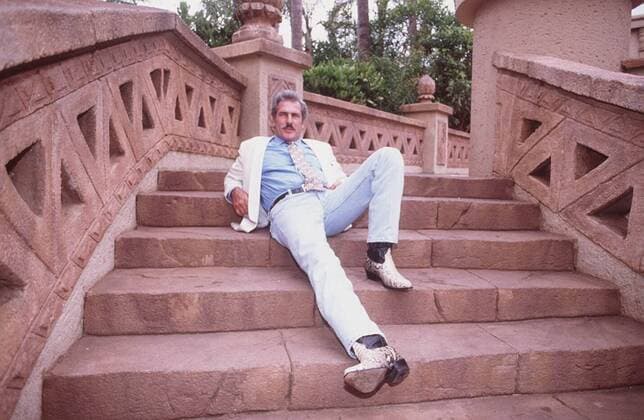 Andres Garcia 11 94 mapo Mann Schauspiel Fernsehen Film Schnäuzer grauhaarig seriös Sakko weiß Krawatte quer ganz liegend Treppe draußen neutral Jeans blau