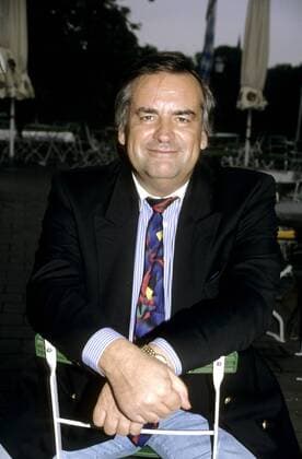 Wolfgang Penk 08 95 kück Mann Fernsehen Management TV dunkelhaarig leger Jackett Krawatte Jeans hoch halb sitzend Stuhl draußen Hände lächelnd