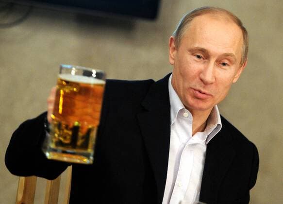 ST. PETERSBURG, RUSSIA. JANUARY 19, 2012. Prime Minister Vladimir Putin holds up a beer mug during his meeting with representatives of football fans unions at a beer restaurant in St Petersburg.  Highlight Premiumd 20120903