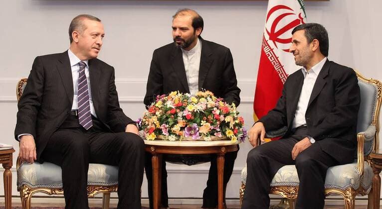 In this official handout, Iran President Mahmoud Ahmadinejad (R) talks with Turkish Prime Minister Recep Tayyip Erdogan during official meeting at the Presidential Palace in Tehran, Iran on March 29, 2012.  TEH20120329102
